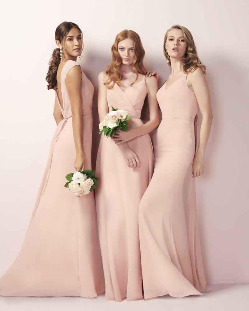 Bridesmaids wearing pastel pink dresses