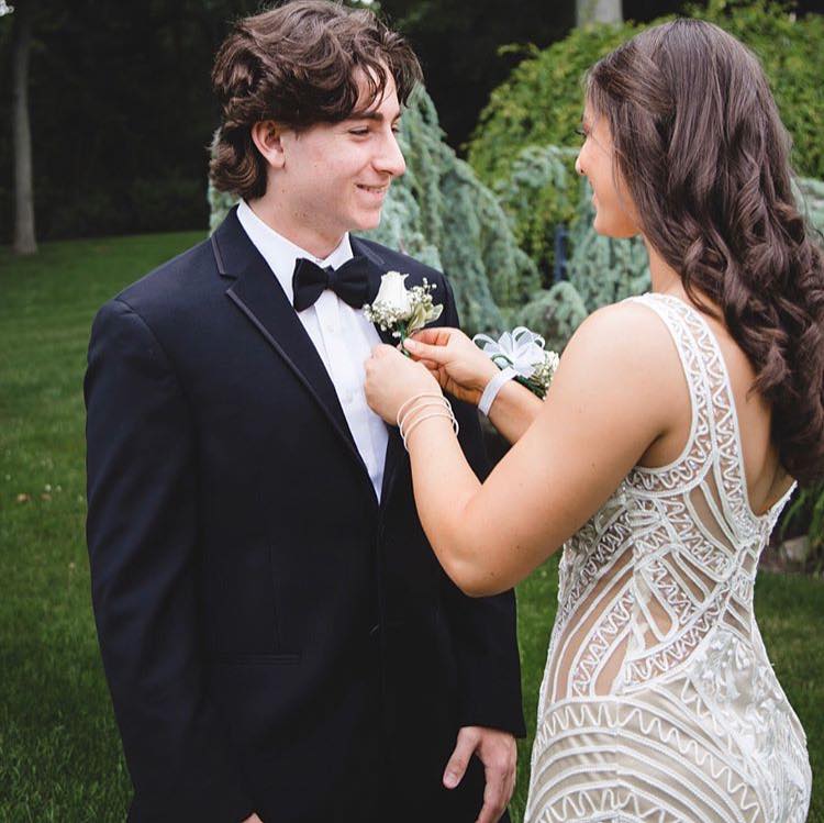 Сouple wearing a white gown and a black suit