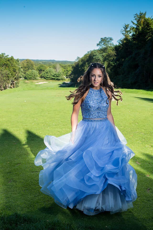 Model wearing a blue gown on the grass