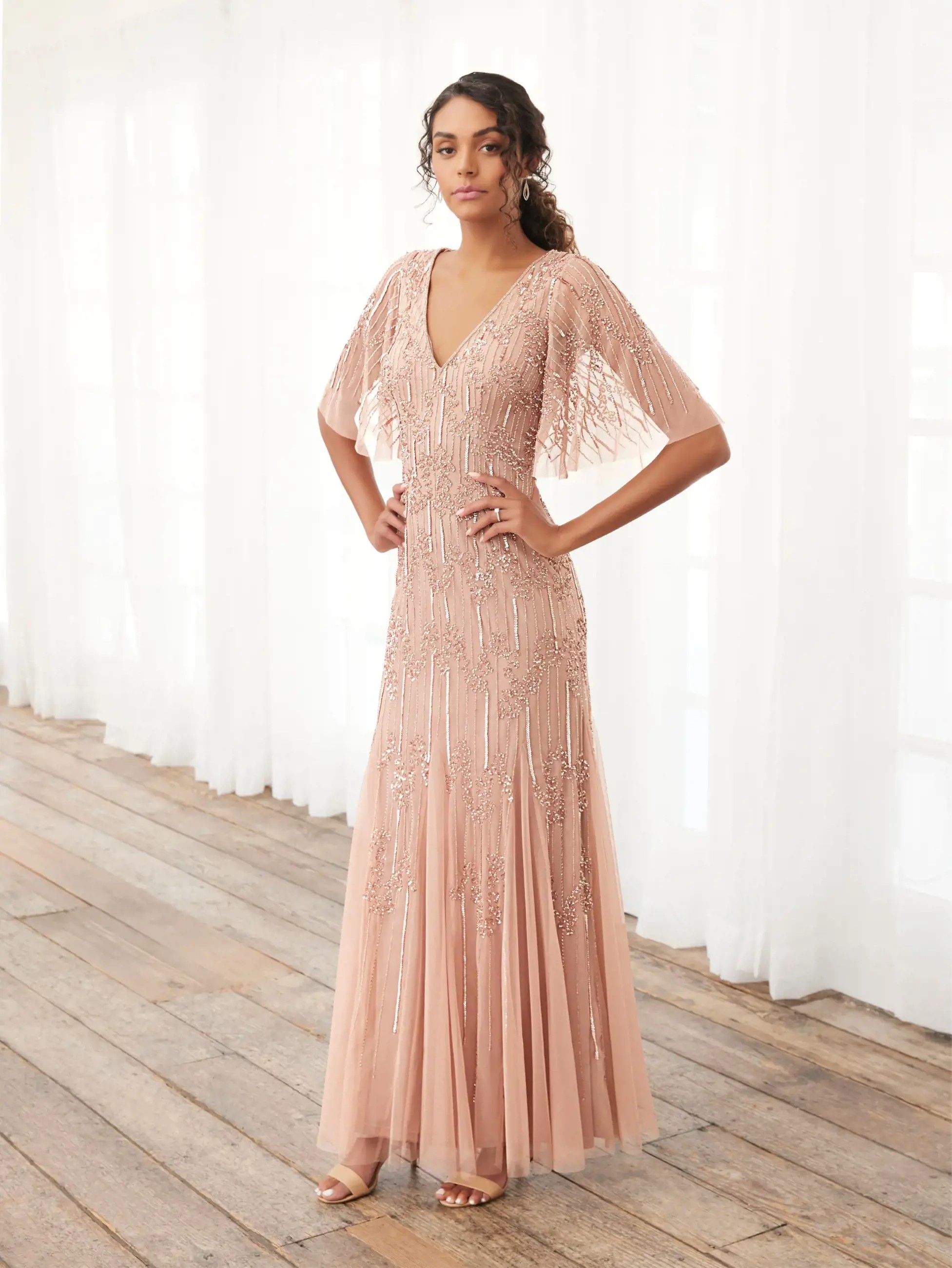 Model wearing a gown by Adrianna Papell